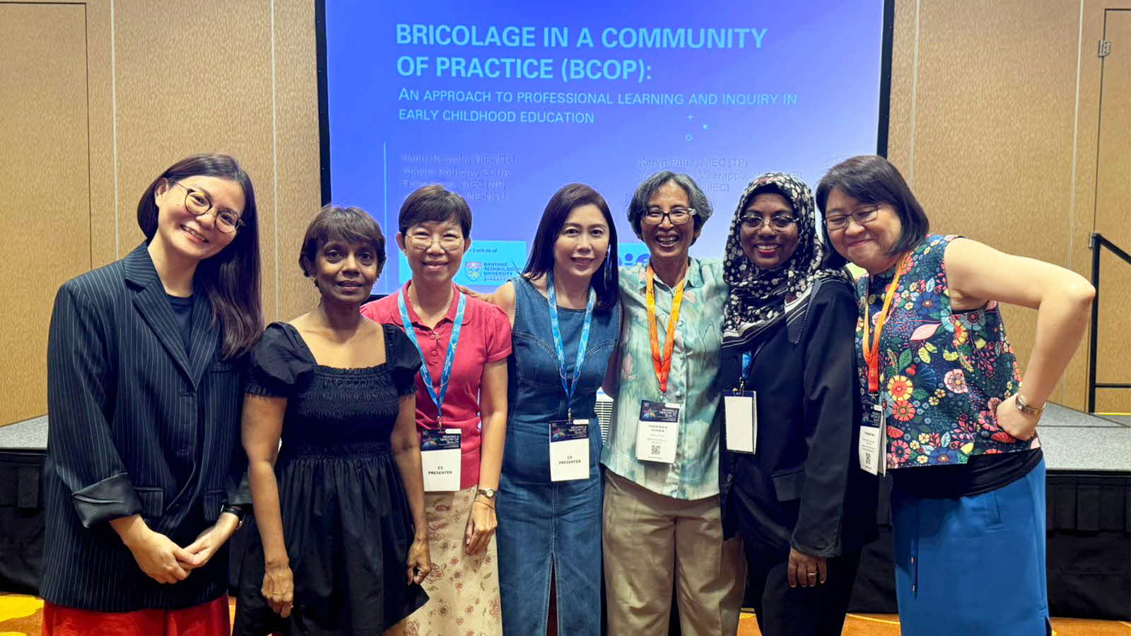 Fiona Leow and her study group mates pose for a photo together in front of a presentation screen.