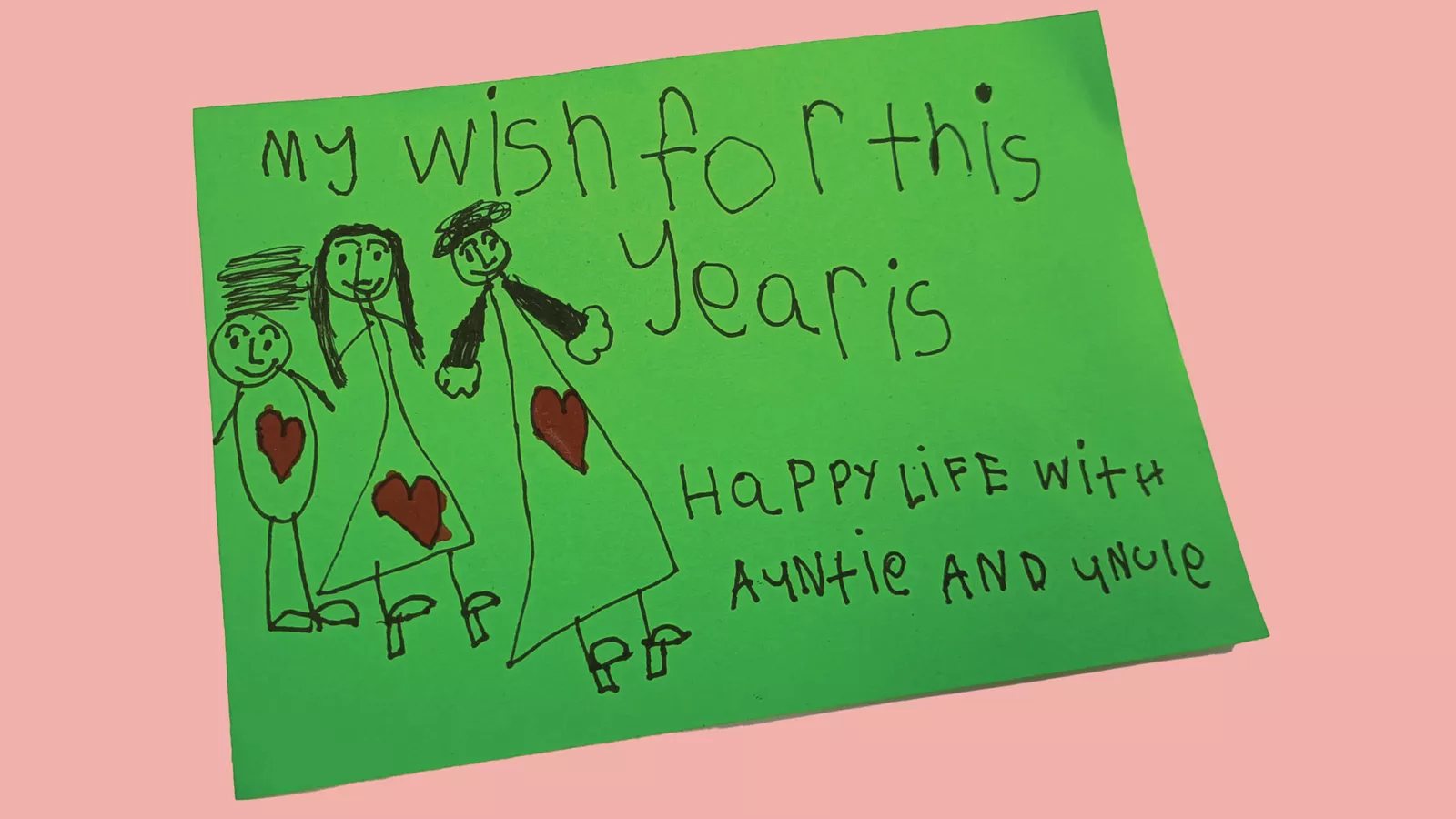 A child’s handwritten note states the child’s wish for seniors to have a happy life, in an example of character education.