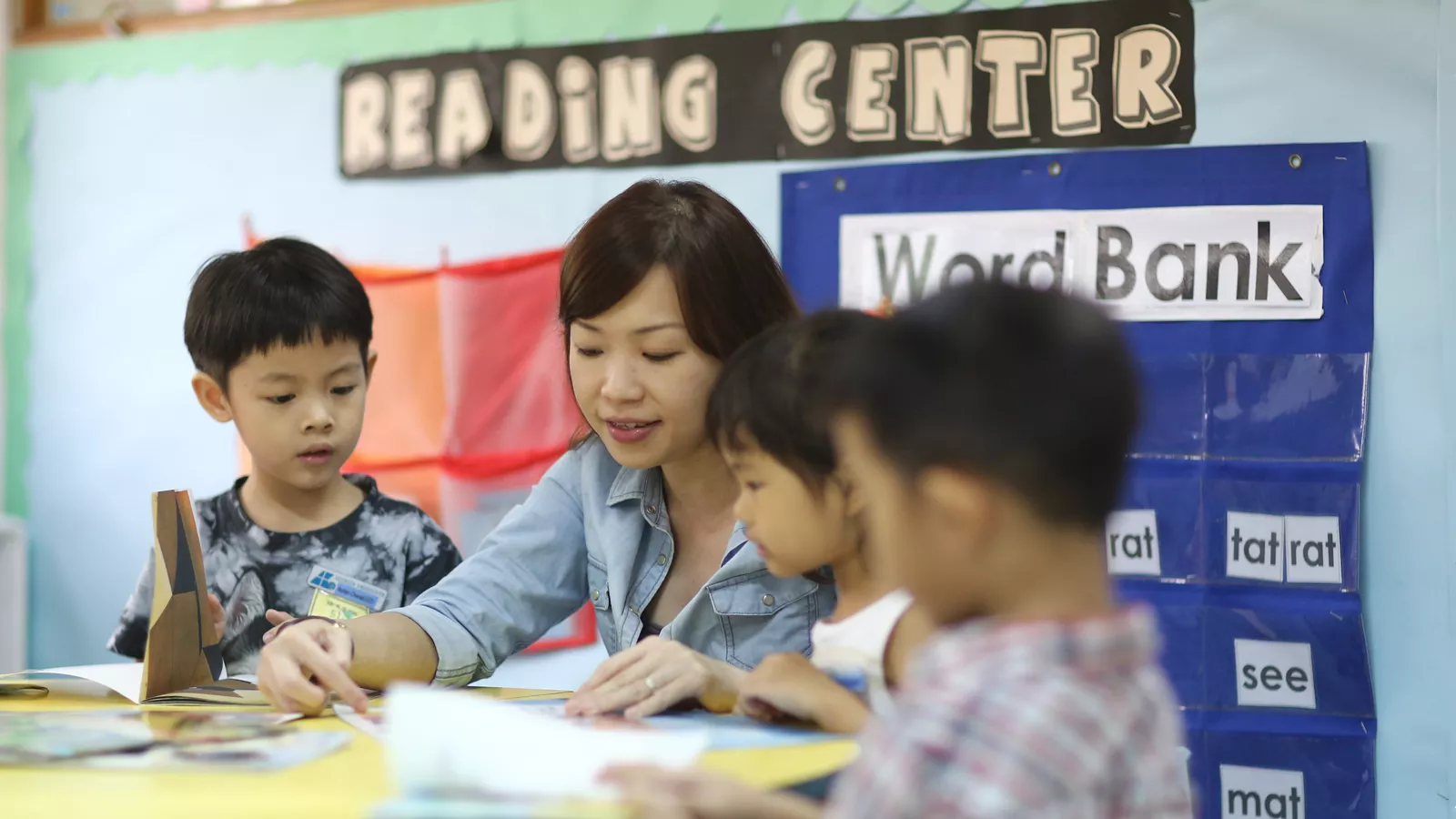 Educators-Inclusive-Practices-IPPG-Hero An educator instructs a group of children in a classroom, promoting inclusive education for children of varying abilities.