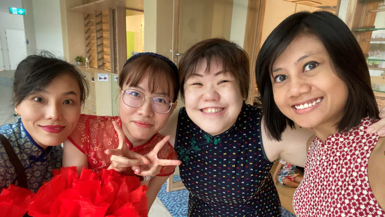 Michelle Lee takes a photo with three of her closest colleagues and friends at the mega childcare centre where she worked.