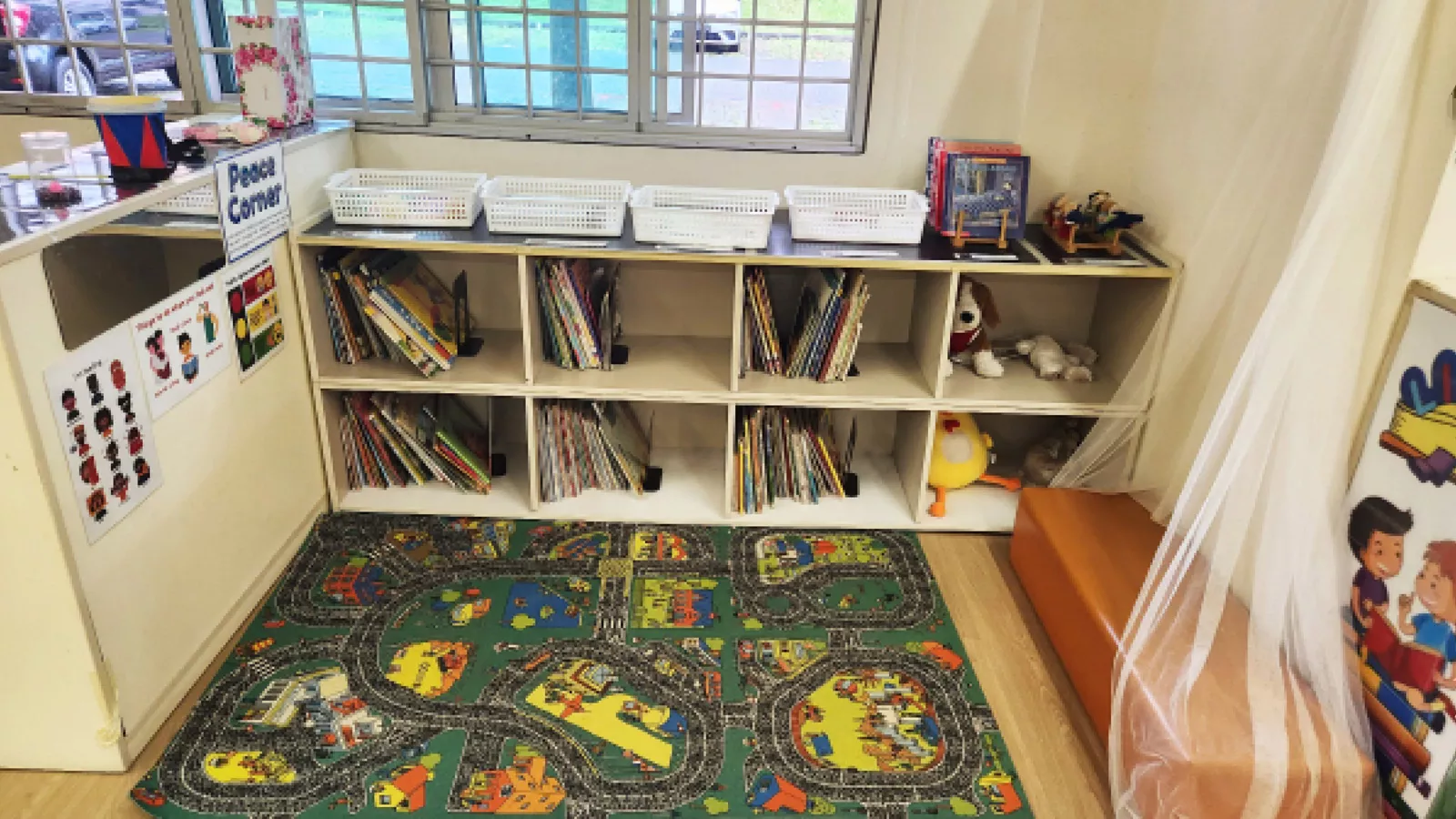The calming corner in a preschool, with books, soft toys, games and other items to help children manage their emotions.