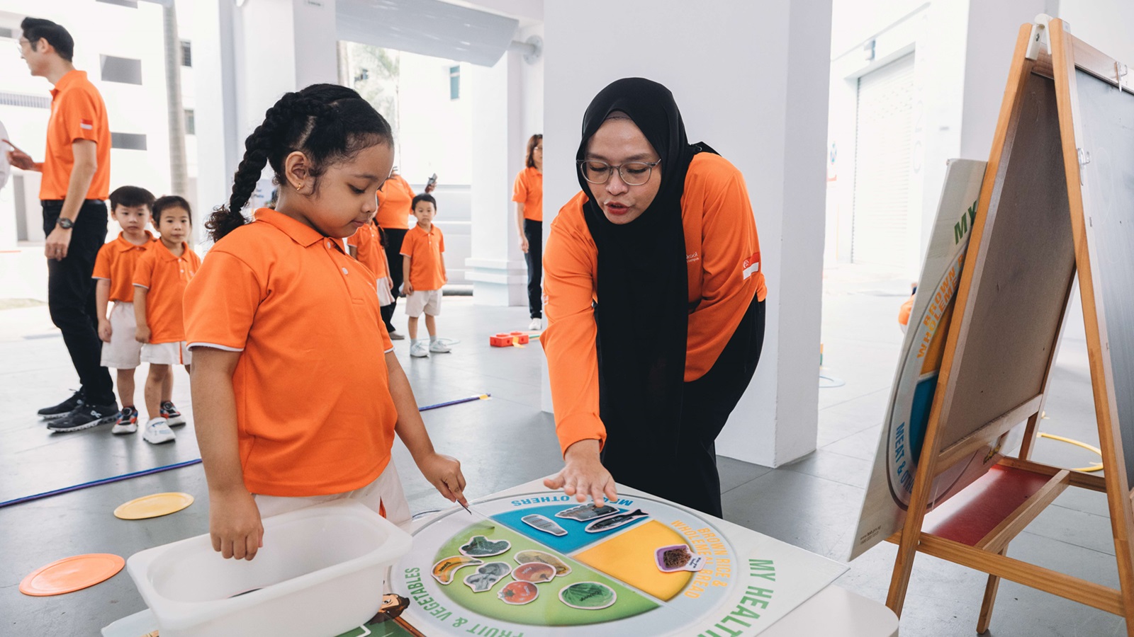 Educator engaging a child on a Health Plan activity