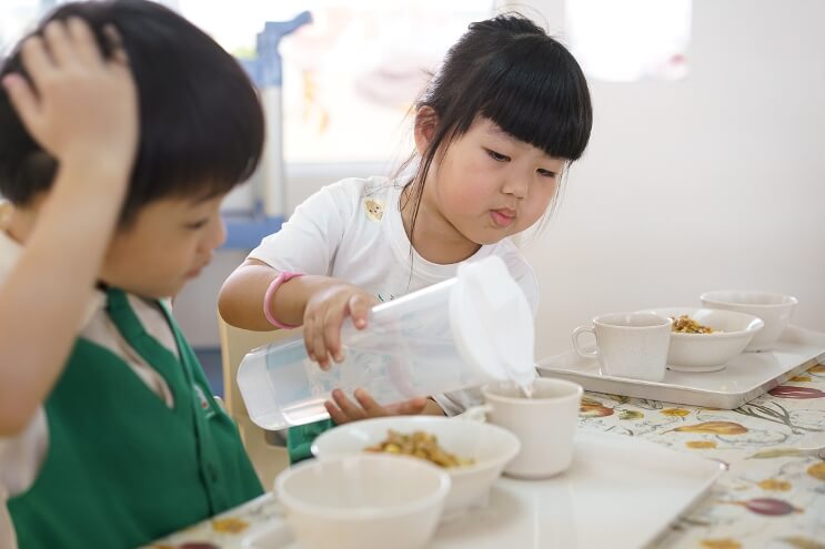Children also serve their peers during mealtimes