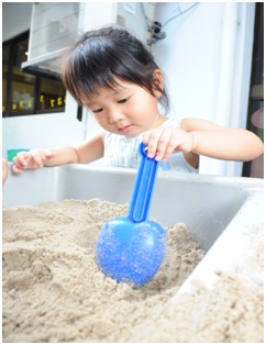 Girl playing with sand