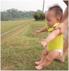Baby stepping on grass