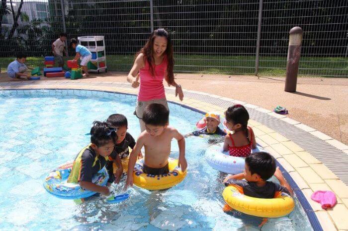 Parent with children at the pool