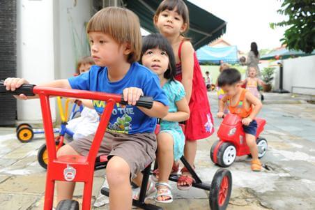 children on tricycle