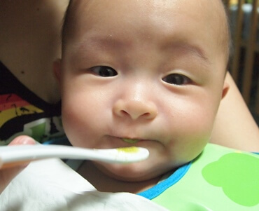 Let baby try solids at 6 months old