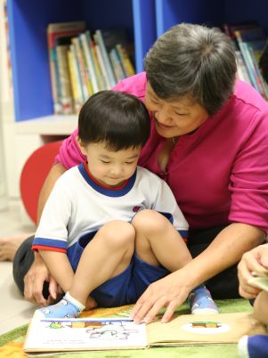 Grandmother reading to grandson