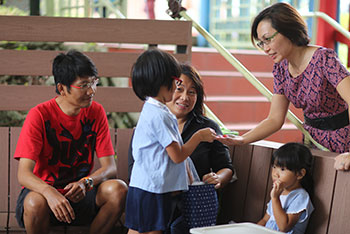female educator engaged with parents and children